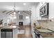 Modern kitchen with stainless steel appliances and a view of the living room with fireplace at 625 Sienna Way, Summerville, SC 29486