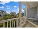 Inviting porch with white columns and railing overlooking a neighborhood at 625 Sienna Way, Summerville, SC 29486