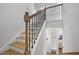 Staircase with stained wood steps and decorative wrought iron railings at 625 Sienna Way, Summerville, SC 29486