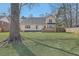 Spacious backyard with well-maintained lawn, a wooden deck, and a privacy fence at 659 Hamlet Cir, Goose Creek, SC 29445