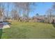 Green backyard featuring patio, deck, privacy fence, and other neighborhood houses at 659 Hamlet Cir, Goose Creek, SC 29445
