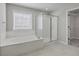Bathroom featuring a soaking tub, glass shower, and walk-in closet at 659 Hamlet Cir, Goose Creek, SC 29445