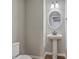 Powder room featuring a pedestal sink, round mirror, and contemporary lighting at 659 Hamlet Cir, Goose Creek, SC 29445