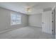 Bright bedroom with a ceiling fan, carpeted floor, and a large window view at 659 Hamlet Cir, Goose Creek, SC 29445