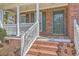 Close-up of the home's front door, porch with columns, and well-manicured steps at 659 Hamlet Cir, Goose Creek, SC 29445