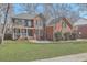 Charming two-story brick home with a well-manicured lawn and classic green shutters at 659 Hamlet Cir, Goose Creek, SC 29445