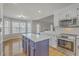 Bright kitchen boasting stainless appliances, white cabinets, and view to sun-drenched breakfast nook at 659 Hamlet Cir, Goose Creek, SC 29445