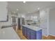 Charming kitchen with white cabinetry, stainless steel appliances, and a striking blue island at 659 Hamlet Cir, Goose Creek, SC 29445