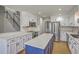 Well-lit kitchen featuring white cabinets, stainless steel appliances, and blue kitchen island at 659 Hamlet Cir, Goose Creek, SC 29445