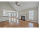 Open-concept living room boasts hardwood floors, fireplace, and access to kitchen and outdoor space at 659 Hamlet Cir, Goose Creek, SC 29445