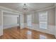 Inviting living room with hardwood floors, large windows, and traditional wainscoting detail at 659 Hamlet Cir, Goose Creek, SC 29445