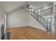 Expansive living room with hardwood floors, high ceilings, fireplace, and staircase to the upper level at 659 Hamlet Cir, Goose Creek, SC 29445