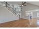 Spacious living room with hardwood floors and open staircase, leading to a modern kitchen at 659 Hamlet Cir, Goose Creek, SC 29445