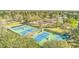 Aerial view of a community tennis courts surrounded by trees on a sunny day at 659 Hamlet Cir, Goose Creek, SC 29445