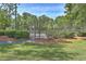 Community tennis courts with black fence, shrubbery, and paved walkways on a sunny day at 659 Hamlet Cir, Goose Creek, SC 29445