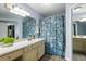 Bathroom with a floral shower curtain, large mirror and ample counter space at 700 Daniel Ellis Dr # 5302, Charleston, SC 29412