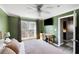 A well-lit bedroom features a ceiling fan and a view of the outdoors at 700 Daniel Ellis Dr # 5302, Charleston, SC 29412
