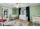 A cozy Bedroom featuring a large window, two cribs, and comfortable seating at 700 Daniel Ellis Dr # 5302, Charleston, SC 29412