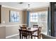 Dining room with square wood table, four chairs and a painting of sailboats on the wall at 700 Daniel Ellis Dr # 5302, Charleston, SC 29412
