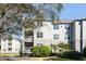 Three-story condominium with white siding, balconies, manicured bushes, and a well-maintained lawn at 700 Daniel Ellis Dr # 5302, Charleston, SC 29412