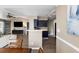 Open concept kitchen overlooking the living and dining rooms with bar top and wooden floor at 700 Daniel Ellis Dr # 5302, Charleston, SC 29412