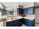 The kitchen features navy cabinets, stainless sink and an open view to the living area at 700 Daniel Ellis Dr # 5302, Charleston, SC 29412