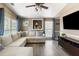 Well-lit living room features a sectional sofa, television, recessed wall display case and wood floors at 700 Daniel Ellis Dr # 5302, Charleston, SC 29412
