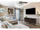 Cozy living room features comfortable sectional sofa, TV, ceiling fan, and hardwood floors at 700 Daniel Ellis Dr # 5302, Charleston, SC 29412