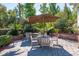 Charming outdoor patio featuring multiple seating areas under umbrellas, complemented by a grill at 700 Daniel Ellis Dr # 5302, Charleston, SC 29412
