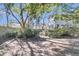 A charming backyard featuring mature trees, lush greenery, and a quaint wooden gate leading to the rest of the property at 726 Gypsy Ln, Mount Pleasant, SC 29464