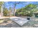 Large backyard with mature trees and patio with outdoor fireplace at 726 Gypsy Ln, Mount Pleasant, SC 29464