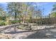 Landscaped backyard with mature trees, water feature, and lush greenery at 726 Gypsy Ln, Mount Pleasant, SC 29464
