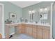 Well-lit bathroom featuring double vanity, decorative mirrors, and neutral color palette at 726 Gypsy Ln, Mount Pleasant, SC 29464