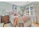 Light and airy bedroom with neutral paint, a plush bed, hardwood flooring and sunny windows at 726 Gypsy Ln, Mount Pleasant, SC 29464