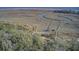 Breathtaking aerial showcases the intertwining waterways and marshes alongside a dense tree line at 7759 Edingsville Beach Rd, Edisto Island, SC 29438