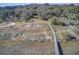 Marsh front home with a boardwalk, yard with chairs, mature trees, and marsh views from above at 7759 Edingsville Beach Rd, Edisto Island, SC 29438