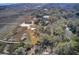 Scenic aerial view of marsh front home featuring a long boardwalk to the ocean with lush, mature trees at 7759 Edingsville Beach Rd, Edisto Island, SC 29438