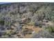 Aerial view of the backyard featuring a gazebo, boardwalk to the river, lawn chairs, and beautiful wooded views at 7759 Edingsville Beach Rd, Edisto Island, SC 29438