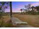 Relaxing backyard setting with a hammock and picturesque sunset view at 7759 Edingsville Beach Rd, Edisto Island, SC 29438