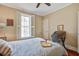 Bedroom featuring a large window with shutters, hardwood floors, and neutral walls at 7759 Edingsville Beach Rd, Edisto Island, SC 29438