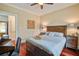Bright bedroom with a window, ceiling fan, and hardwood floors, perfect for relaxation at 7759 Edingsville Beach Rd, Edisto Island, SC 29438