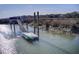 Waterfront dock with a kayak lift, tidal creek access, and beautiful scenery including a bench and handrails at 7759 Edingsville Beach Rd, Edisto Island, SC 29438