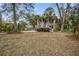 Charming two-story home with a welcoming front porch and lush landscaping and lovely palm trees at 7759 Edingsville Beach Rd, Edisto Island, SC 29438
