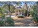 Charming two-story home surrounded by trees and a well-manicured lawn, offering a peaceful setting at 7759 Edingsville Beach Rd, Edisto Island, SC 29438