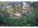 Two story home surrounded by lush trees, adding privacy and natural beauty to the property at 7759 Edingsville Beach Rd, Edisto Island, SC 29438