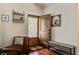 Well-lit foyer with wooden flooring, charming bench, coat rack, and an inviting, paneled front door at 7759 Edingsville Beach Rd, Edisto Island, SC 29438