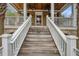 Charming front porch with decorative ceiling fans and welcoming entrance at 7759 Edingsville Beach Rd, Edisto Island, SC 29438