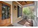 Cozy front porch with a table and chairs, offering a tranquil outdoor seating area to enjoy the surrounding nature at 7759 Edingsville Beach Rd, Edisto Island, SC 29438