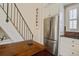 Modern kitchen featuring stainless steel appliances, wooden table, and staircase at 7759 Edingsville Beach Rd, Edisto Island, SC 29438