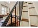 View from the staircase into the open-concept living room with stainless appliances at 7759 Edingsville Beach Rd, Edisto Island, SC 29438